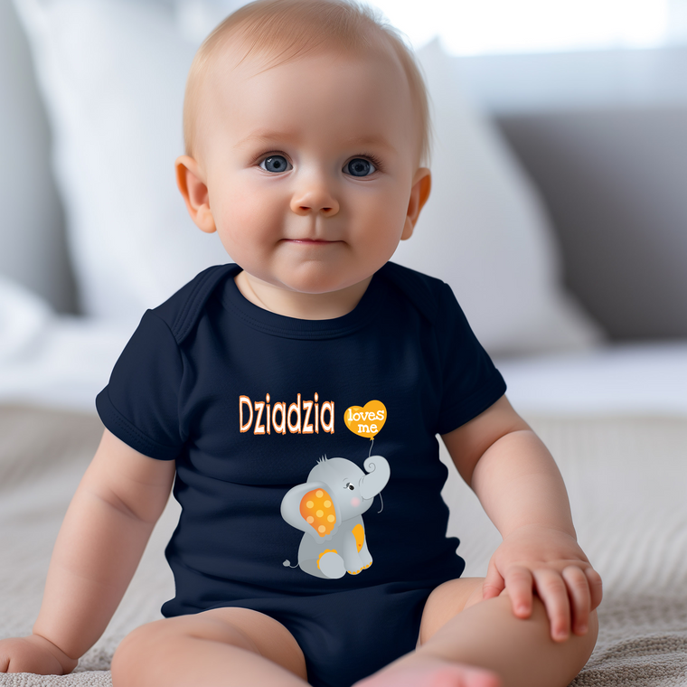 A smiling baby wearing a blue shirt with an elephant graphic and the text "Dziańszty" printed on it.
