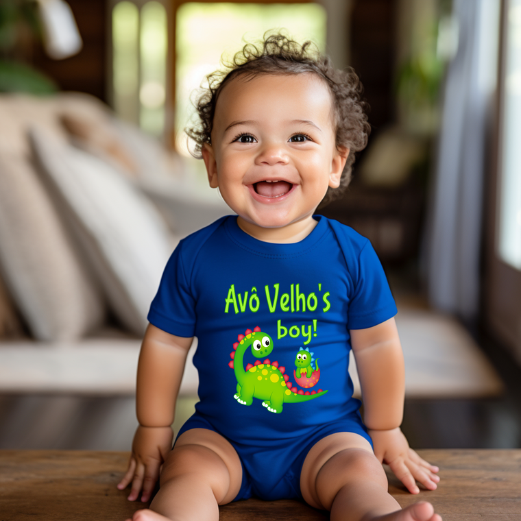 A smiling baby boy wearing a blue onesie with a dinosaur design and text.
