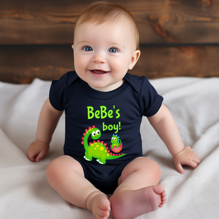 A smiling baby wearing a black t-shirt with a dinosaur graphic and text.