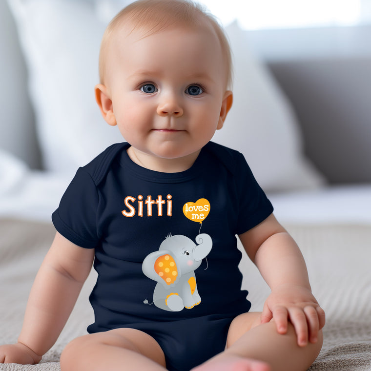 A smiling baby boy wearing a blue shirt with an elephant graphic and the text "Sitti loves me" printed on it.