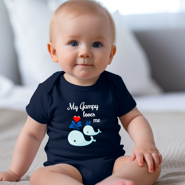 A smiling baby wearing a navy blue t-shirt with a graphic of a whale and the text "My Gumpy loves me" printed on it.